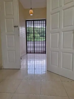 an empty room with a door and a gate at Seaput Srisayang in Batu Ferringhi