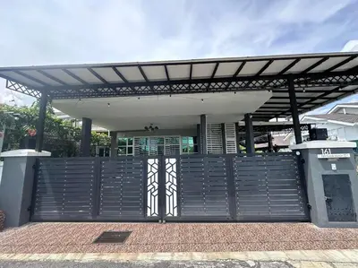 a gate with a wooden fence in front of a building at Nurasyura Puncak Guesthouse in Seri Iskandar