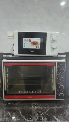 a microwave sitting on top of a toaster oven at AY Homestay Midtown Falim in Ipoh