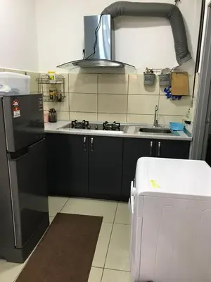 a kitchen with a sink and a stove top oven at Palas at Cameron Highland in Cameron Highlands