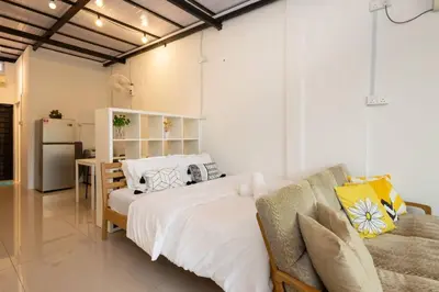 a bedroom with a large bed and a couch at Casa for 2 - Private Studio Ipoh in Ipoh