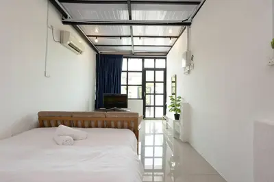 a bedroom with a bed and a desk with a computer at Casa for 2 - Private Studio Ipoh in Ipoh