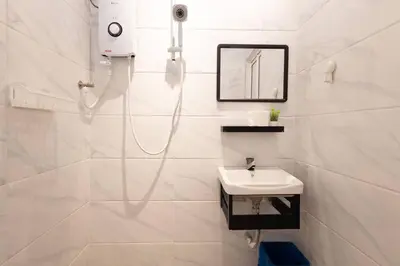 a white bathroom with a sink and a shower at Casa for 2 - Private Studio Ipoh in Ipoh
