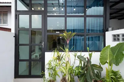 an open door of a building with plants at Casa for 2 - Private Studio Ipoh in Ipoh