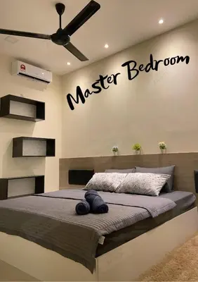 a bedroom with a master bed with a sign on the wall at Homestay Khan'Da Teluk Intan in Teluk Intan