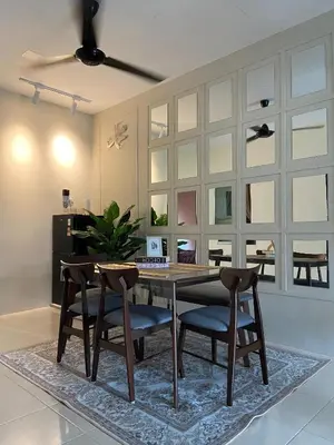 a dining room with a wooden table and chairs at Homestay Khan'Da Teluk Intan in Teluk Intan