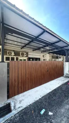 awning over a wooden fence in front of a house at Homestay Khan'Da Teluk Intan in Teluk Intan