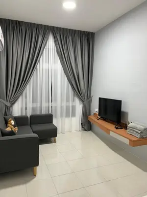 a living room with a couch and a television at Ipoh Town Anderson Haru Suite 7 paxs 2R2B in Ipoh