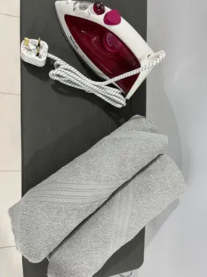 a red and white object on a wall with a towel at Ipoh Town Anderson Haru Suite 7 paxs 2R2B in Ipoh