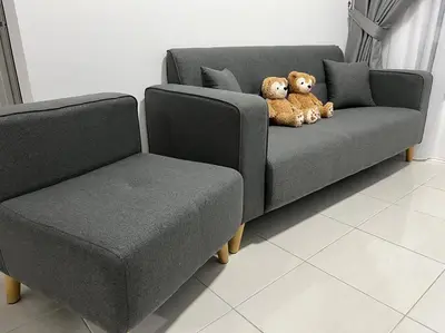 a teddy bear sitting on a couch next to a chair at Ipoh Town Anderson Hana Suite 7 paxs 2R2B in Ipoh