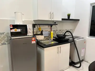 a small kitchen with a sink and a microwave at Ipoh Town Anderson Hana Suite 7 paxs 2R2B in Ipoh
