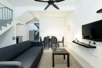 a living room with a couch and a tv at Mono Ipoh - Bercham, 2 parking, sleep 10, Lost World Tambun in Ipoh