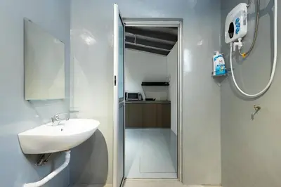 a bathroom with a sink and a shower with a mirror at Mono Ipoh - Bercham, 2 parking, sleep 10, Lost World Tambun in Ipoh