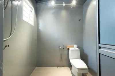 a bathroom with a white toilet and a window at Mono Ipoh - Bercham, 2 parking, sleep 10, Lost World Tambun in Ipoh
