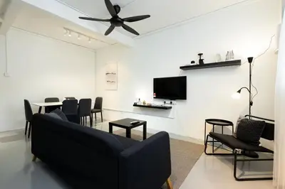 a living room with a couch and chairs and a tv at Mono Ipoh - Bercham, 2 parking, sleep 10, Lost World Tambun in Ipoh