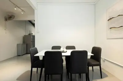 a dining room with a white table and chairs at Mono Ipoh - Bercham, 2 parking, sleep 10, Lost World Tambun in Ipoh