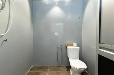 a bathroom with a toilet and a shower at Mono Ipoh - Bercham, 2 parking, sleep 10, Lost World Tambun in Ipoh