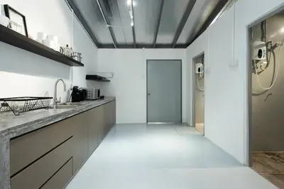 a kitchen with a sink and a door to a hallway at Mono Ipoh - Bercham, 2 parking, sleep 10, Lost World Tambun in Ipoh