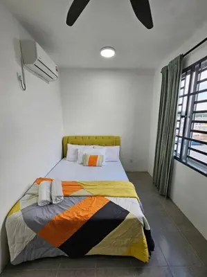 a bedroom with a bed with a colorful blanket at E! Best Apartment in Padang Serai