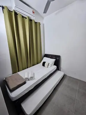 a small room with a bed with green curtains at E! Best Apartment in Padang Serai