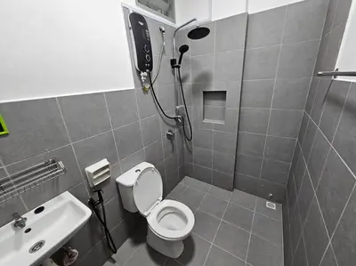 a small bathroom with a toilet and a sink at E! Best Apartment in Padang Serai
