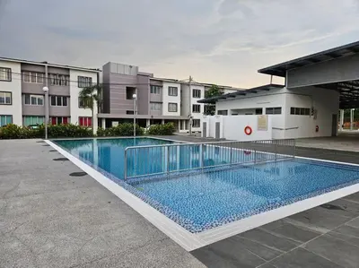 a large swimming pool in front of a building at E! Best Apartment in Padang Serai