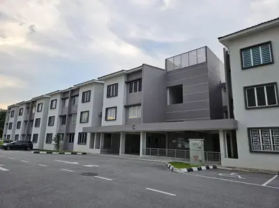 a building with a parking lot in front of it at E! Best Apartment in Padang Serai