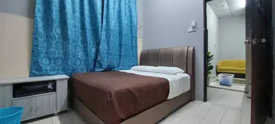a bedroom with a bed and a blue curtain at Sobey Laris Roomstay GUA MUSANG in Gua Musang