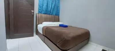 a small bed with a blue box on top of it at Sobey Laris Roomstay GUA MUSANG in Gua Musang