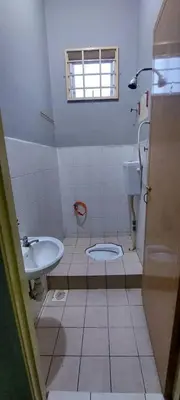 a small bathroom with a toilet and a sink at Sobey Laris Roomstay GUA MUSANG in Gua Musang
