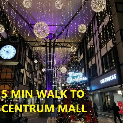 a mall with a christmas tree and a clock at HOTEL POP ASH in Brinchang