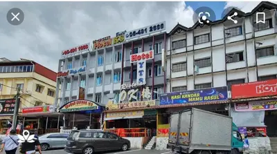 a large building with many signs in a city at HOTEL POP ASH in Brinchang
