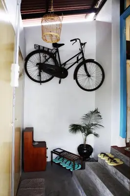 a bike hanging on a wall in a room at Sojourn Beds & Cafe in Taiping