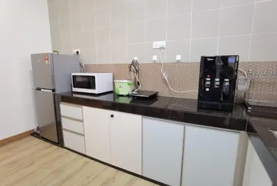 a kitchen with a black counter top with a microwave at Cosy 2-Storey Holiday Home Vines 2 @Pasar Malam -2 in Tanah Rata