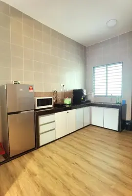 a kitchen with white cabinets and a stainless steel refrigerator at Cosy 2-Storey Holiday Home Vines 2 @Pasar Malam -2 in Tanah Rata