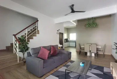 a living room with a couch and a table at Cosy 2-Storey Holiday Home Vines 2 @Pasar Malam -2 in Tanah Rata
