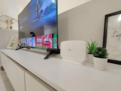 a white counter with a tv on top of it at Sunway Tambun Salesman Stay 5 Bedroom 10pax by IWH in Ipoh