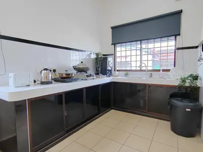 a large kitchen with a counter and a sink at Sunway Tambun Salesman Stay 5 Bedroom 10pax by IWH in Ipoh