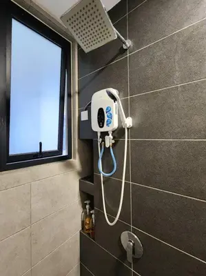 a shower in a bathroom with a phone on the wall at Modern Luxe Island Suites #3BR in Jelutong