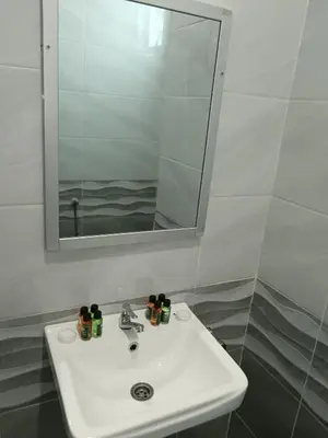 a bathroom with a sink and a mirror at river hotel in Simpang