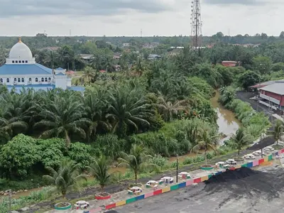an aerial view of a city with a river and trees at river hotel in Simpang