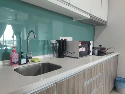 a kitchen counter with a sink and a microwave at THE MAJESTIC IPOH A20 by ZamanJa in Ipoh