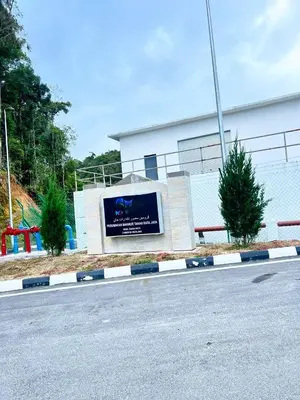 a building with a sign on the side of a road at PMRTJ BY D Atas Bukit Antarium in Tanah Rata