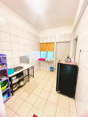 a white tiled kitchen with a table in a room at PMRTJ BY D Atas Bukit Antarium in Tanah Rata