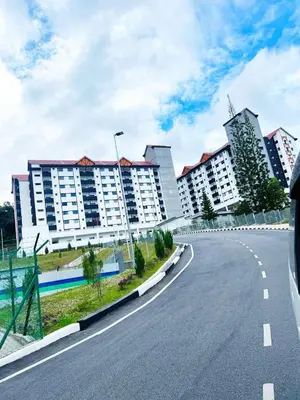 an empty road in front of some buildings at PMRTJ BY D Atas Bukit Antarium in Tanah Rata