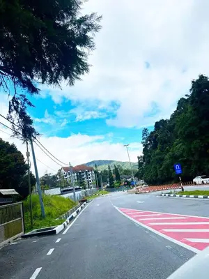 an empty street with a red and white crosswalk at PMRTJ BY D Atas Bukit Antarium in Tanah Rata