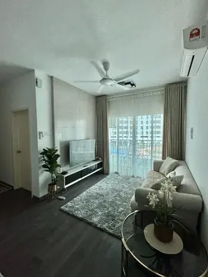 a living room with a couch and a tv at Livistona Luxe Apartment in Permatang Pauh