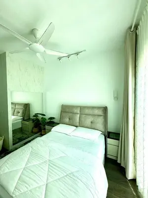 a bedroom with a bed and a ceiling fan at Livistona Luxe Apartment in Permatang Pauh
