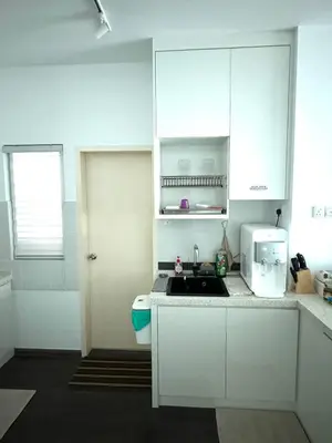 a white kitchen with a sink and a microwave at Livistona Luxe Apartment in Permatang Pauh