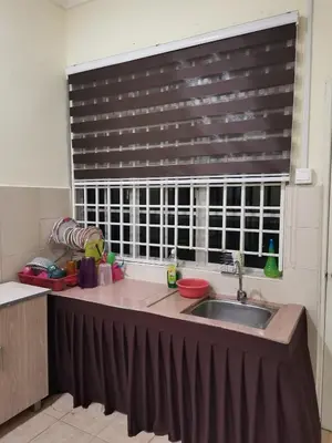 a kitchen with a sink and a large window at Jalinan Qaseh Homestay in Seri Manjung